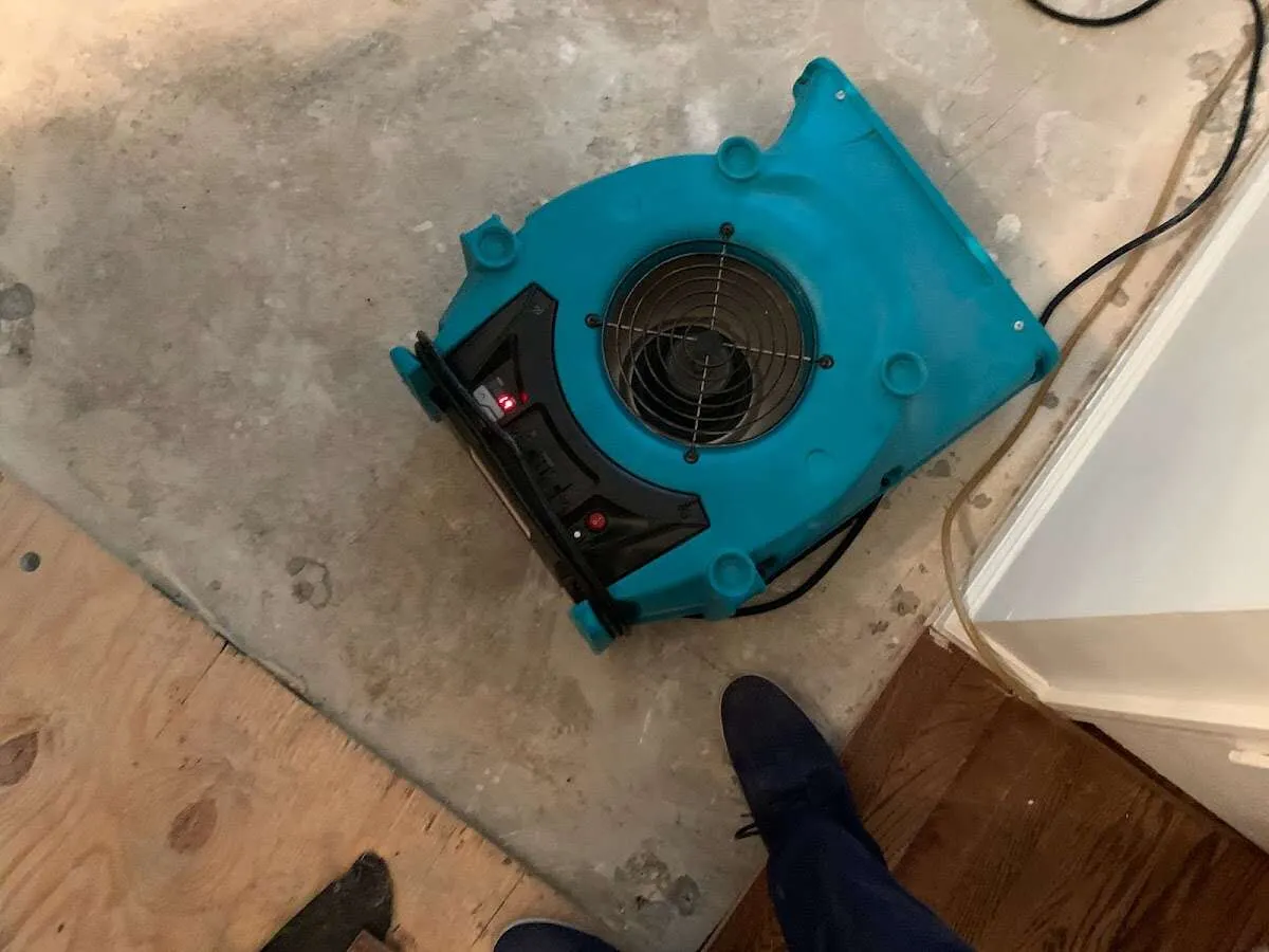 Air mover drying subfloor during Leak Detection & Repair in Prien